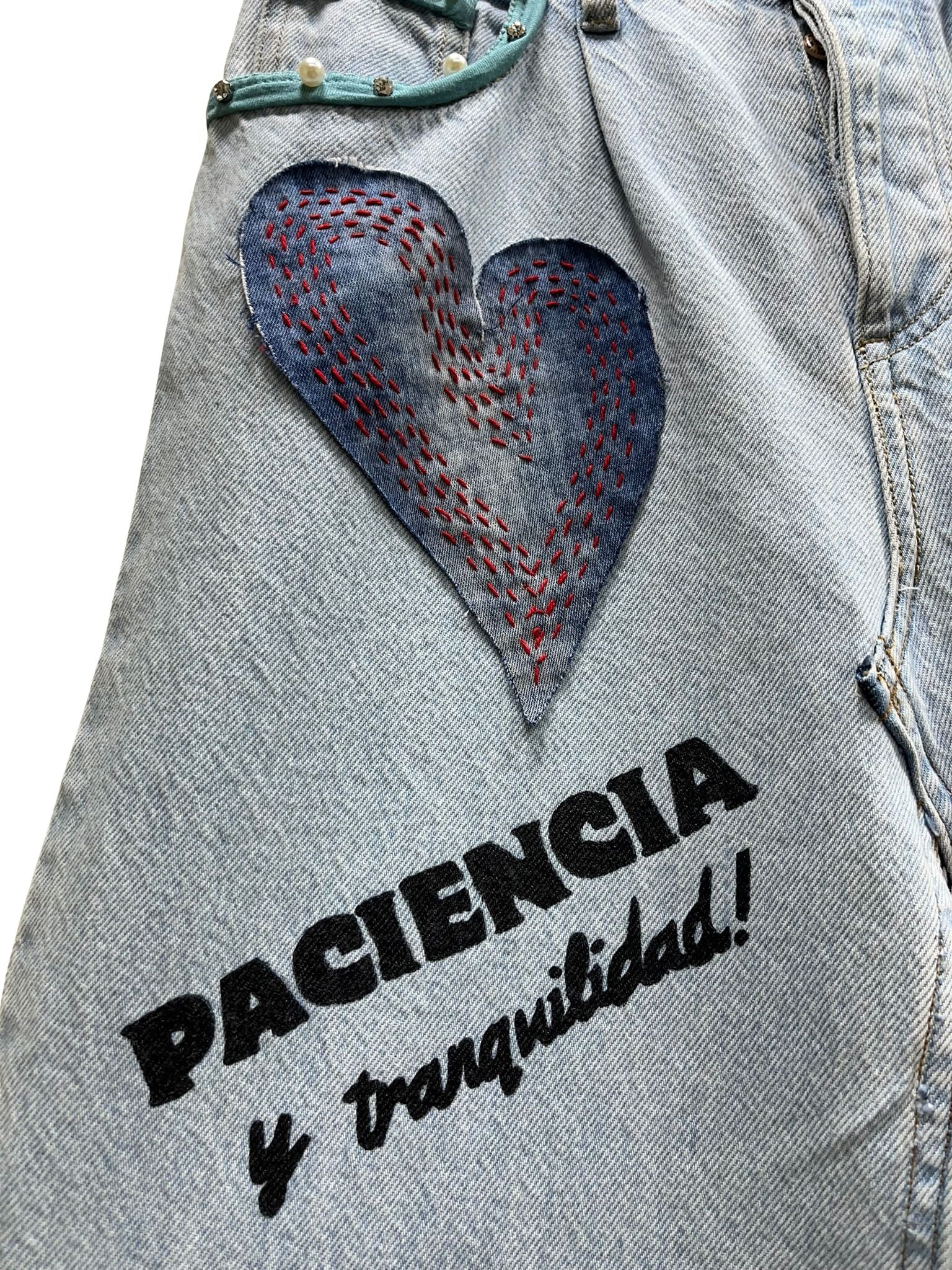 “Falda Hilena detalle de denim reciclado con pedrería, frase pintada a mano y parche de lentejuelas reversibles.”